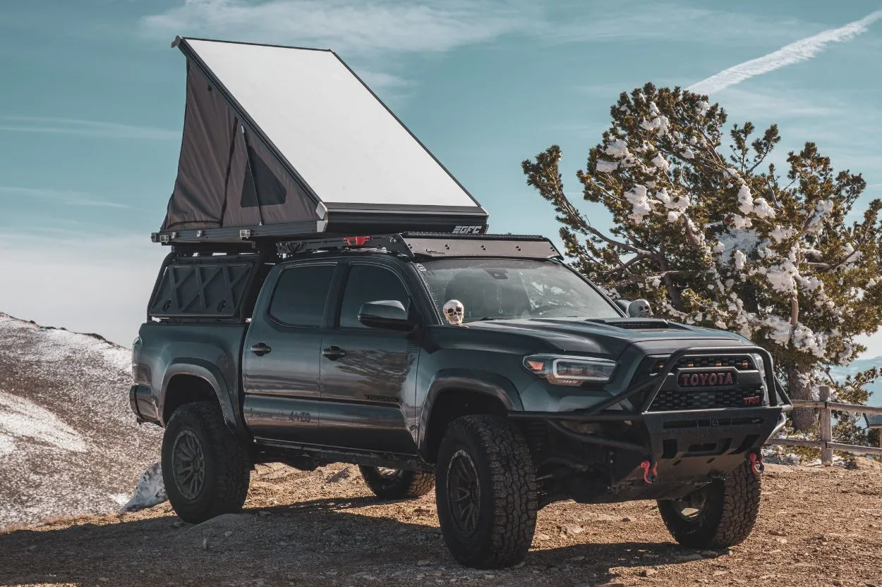 A rooftop tent mounted on a Toyota Tacoma bed rack