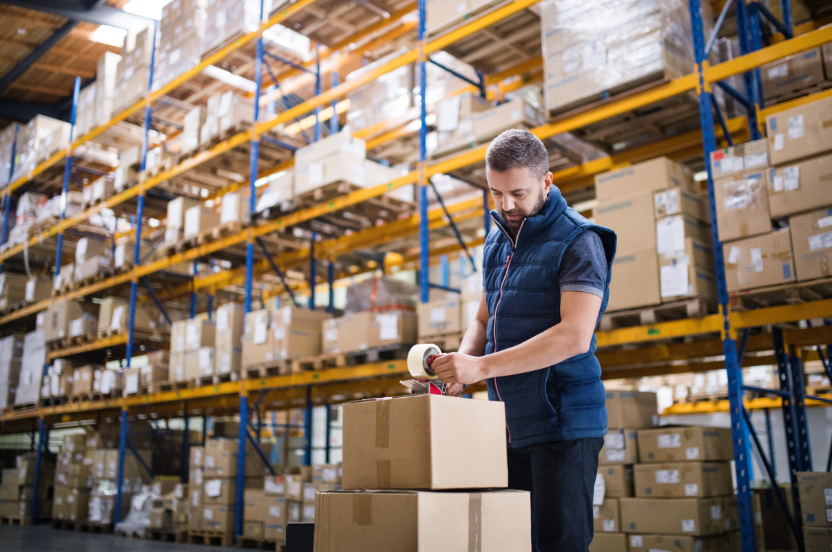 Warehouse worker taping up box