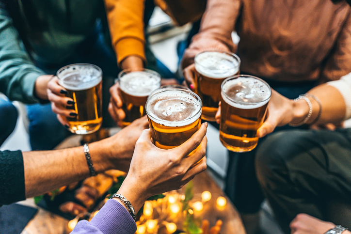 Group of friends toasting with beer.