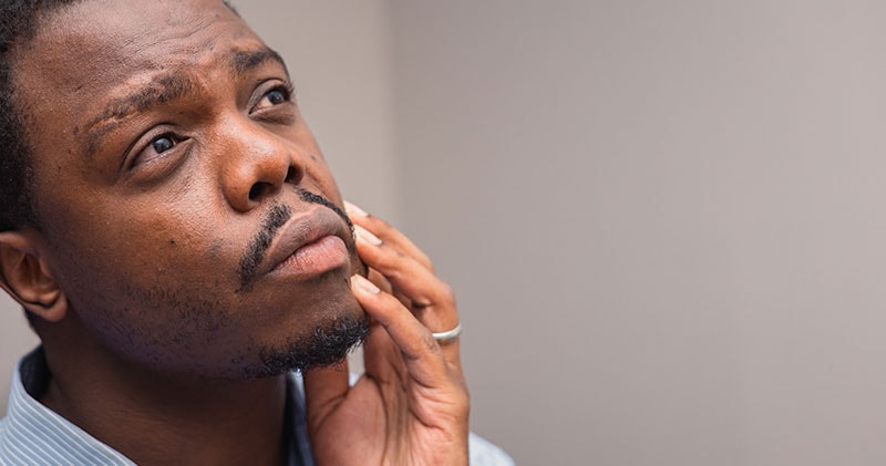 A man deep in thought symbolizes perspective and mental clarity.