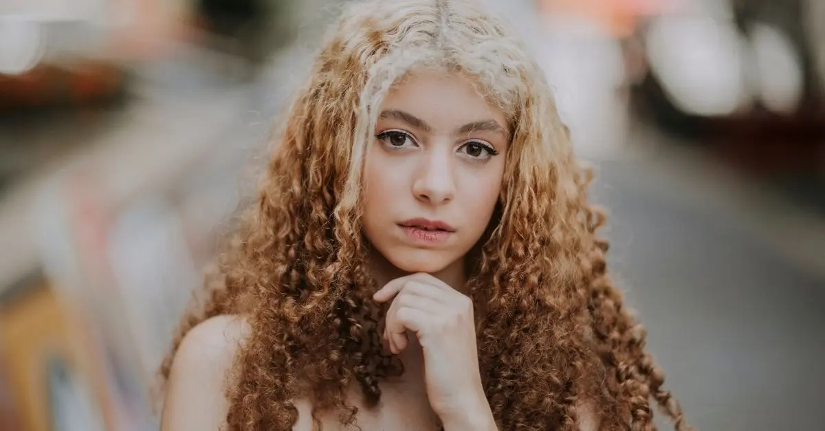 An OnlyFans freelancer considering the complexities of freelancing and taxes with a focused expression.