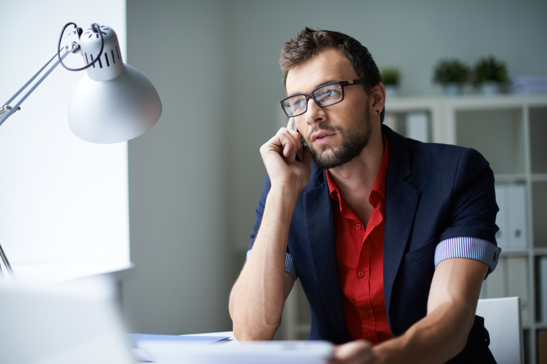 Nutrition brand owner speaking on the phone while reviewing manufacturer evaluation data