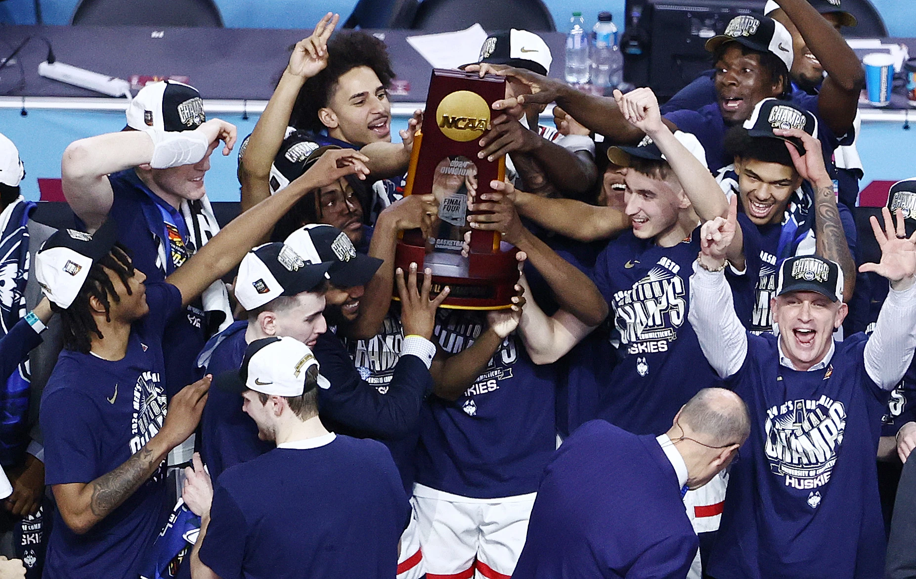 The Connecticut Huskies celebrate after defeating the Purdue Boilermakers in the NCAA Men's Basketball Tournament National Championship game at State Farm Stadium on April 08, 2024 in Glendale, Arizona. 