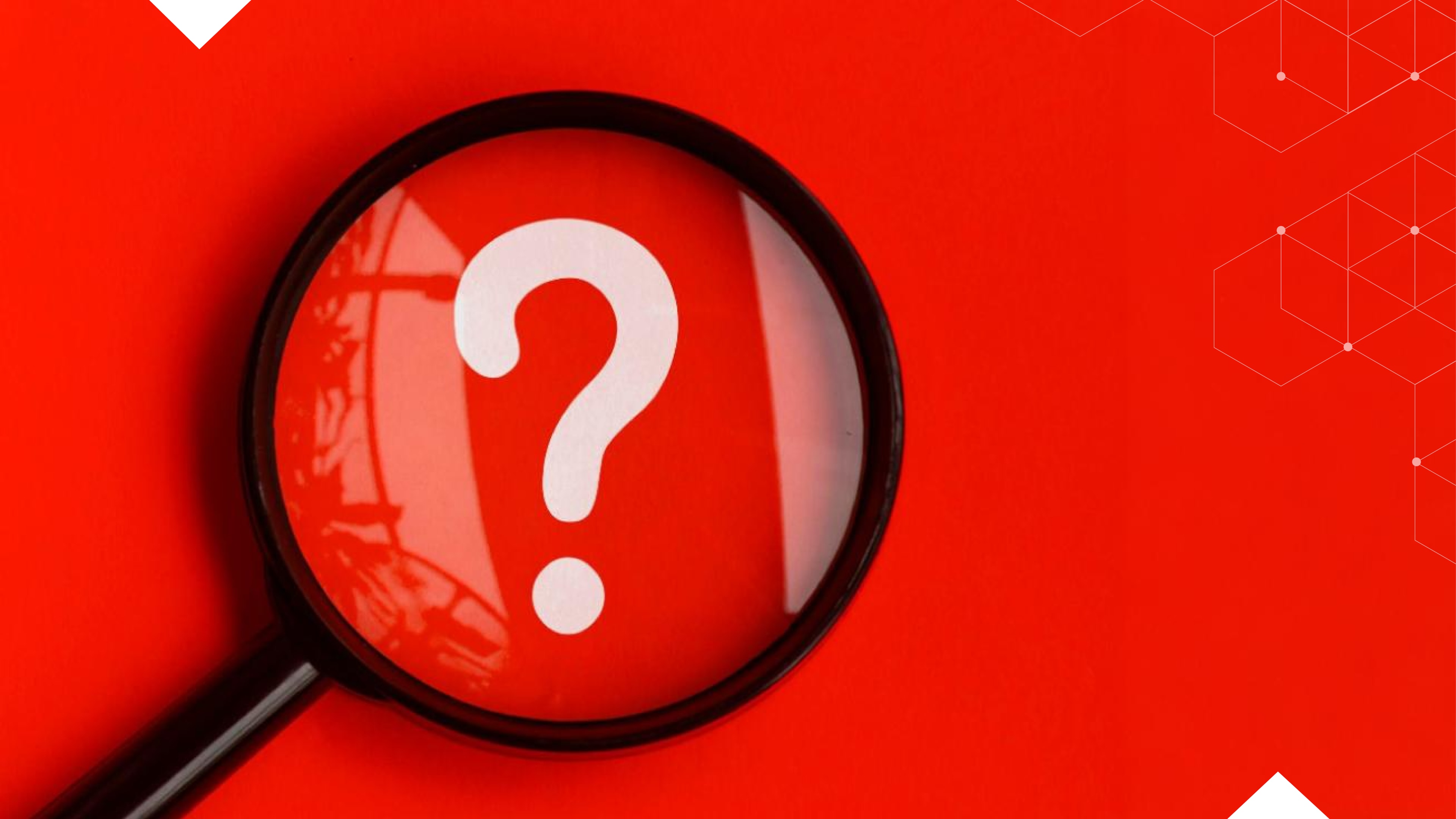 Magnifying glass over a white question mark on a red background, suggesting inquiry or uncertainty—ideal for addressing FAQs about hosted phone systems.