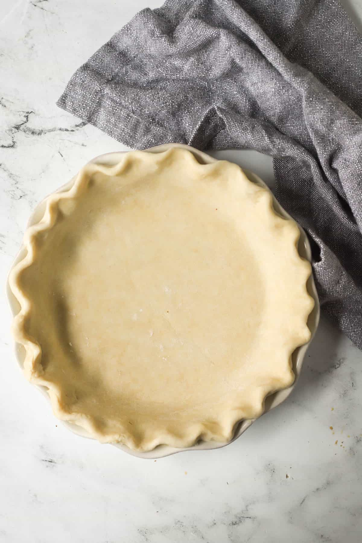 pie crust in a white pie plate