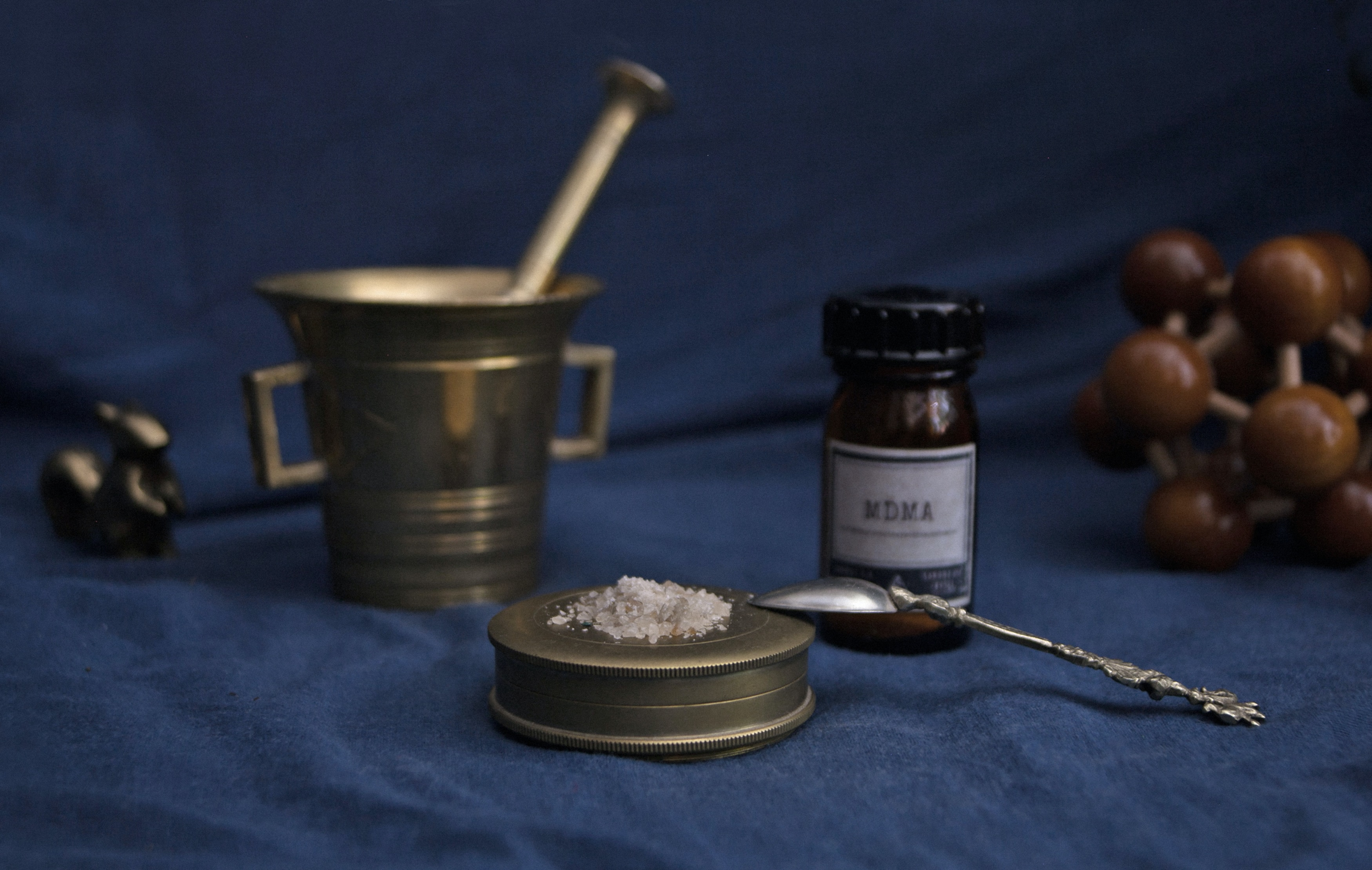 powder on a brass plate bottle cup blue background