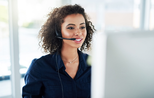 Pretty dark-haired young woman wearing a headset. 