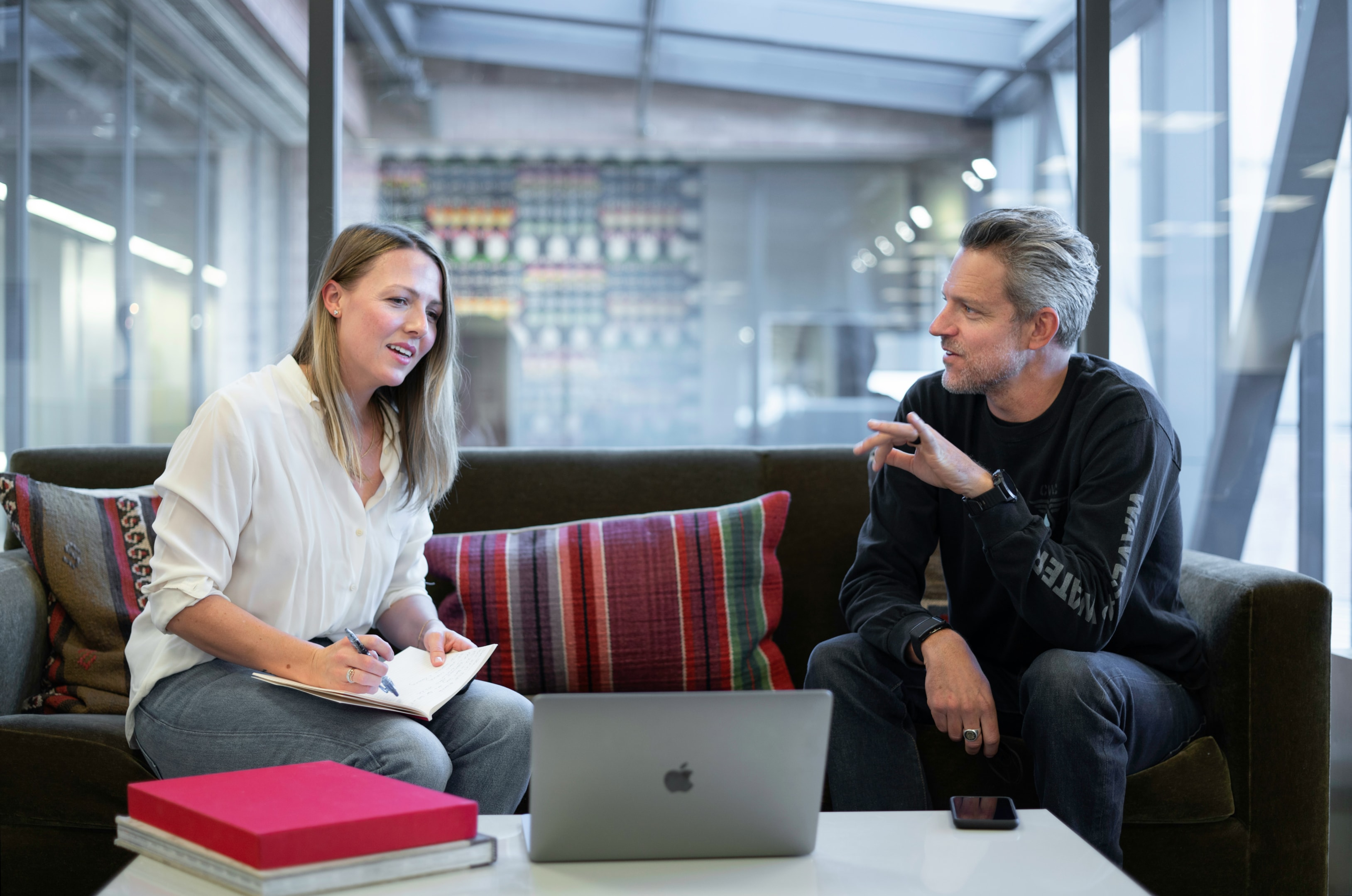 Real estate investor team meets to discuss marketing channels.