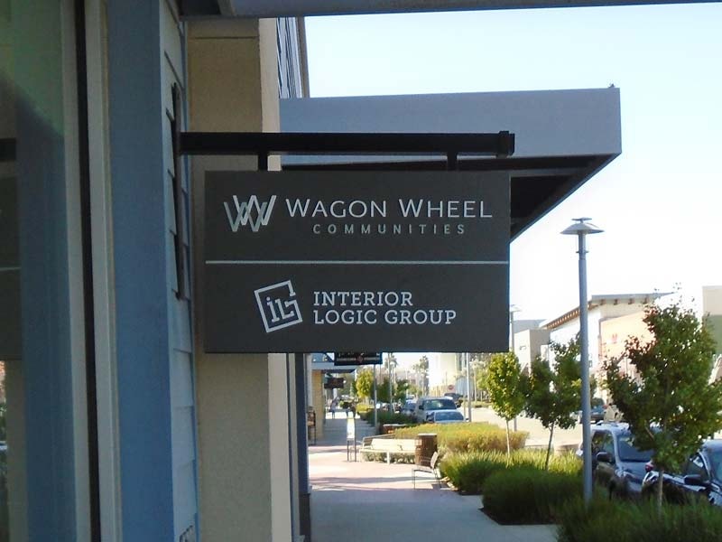 Blade signs for Wagon Wheel Communities and Interior Logic Group make both businesses easy to spot and add a professional look to the storefronts.