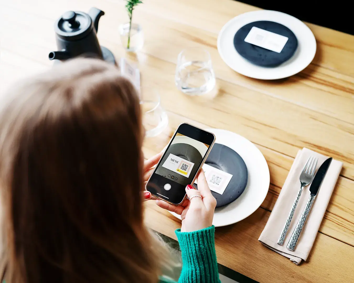 Restaurant customer scanning QR code digital menu on smartphone, showcasing modern digital marketing and customer engagement