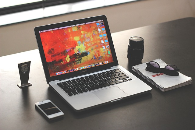 Phone, laptop, and notebook on desk. Source: Surfer AI powered by Pixabay