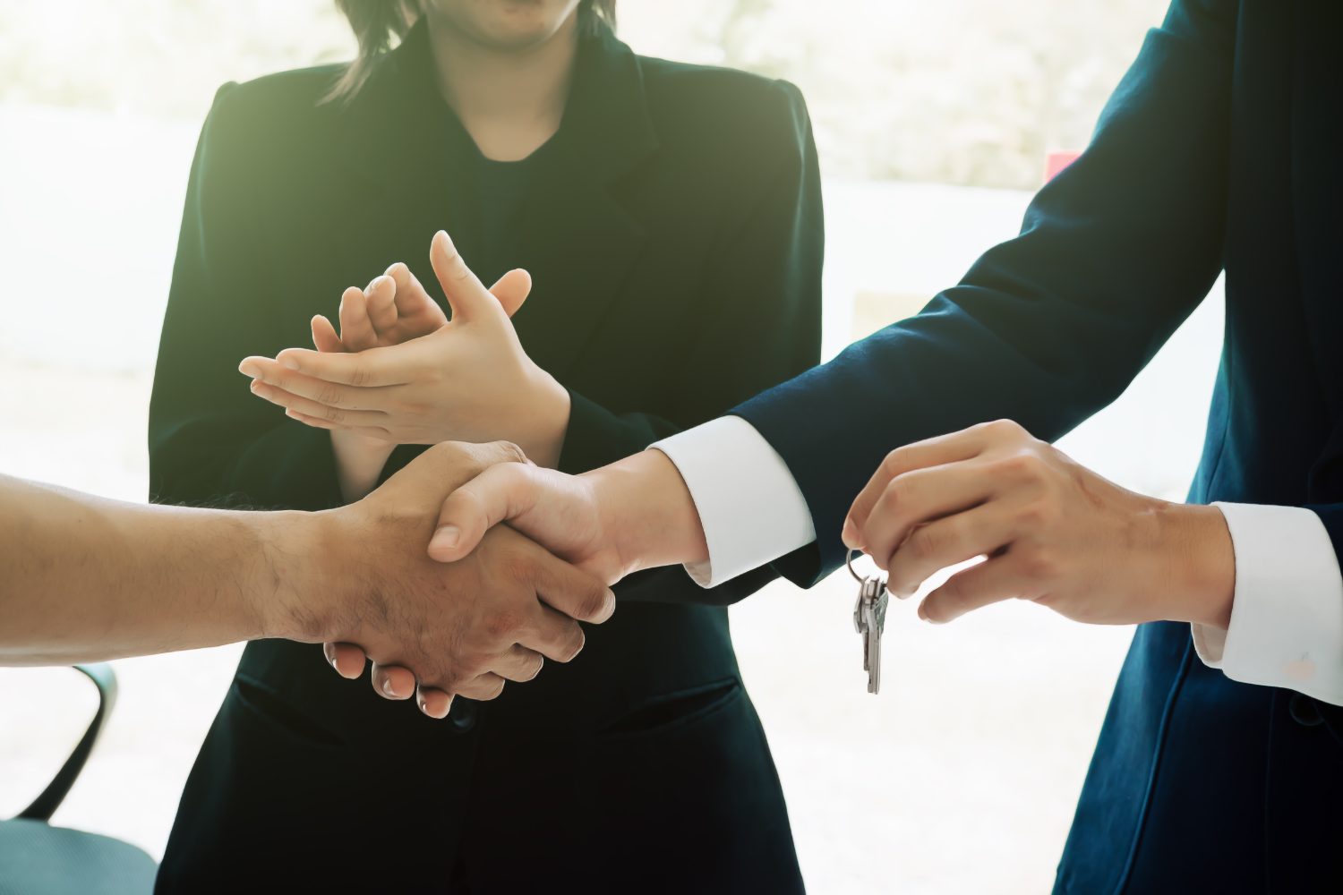 Brokers and sellers shaking hands and clapping.