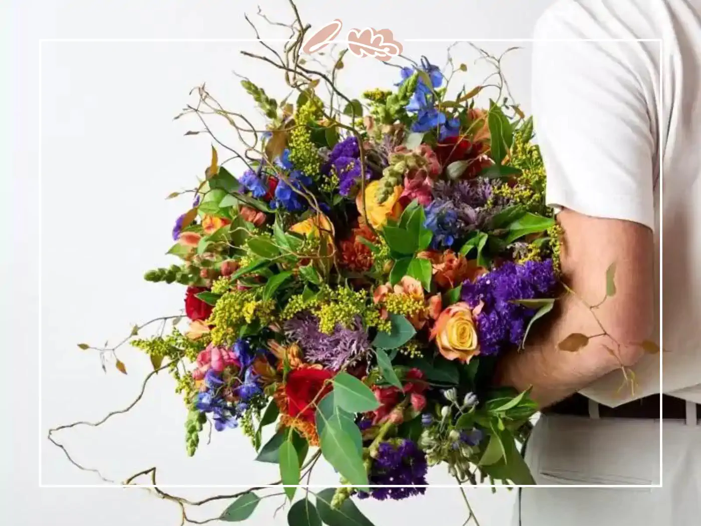 Man holding a large, colorful bouquet of flowers - Fabulous Flowers and Gifts