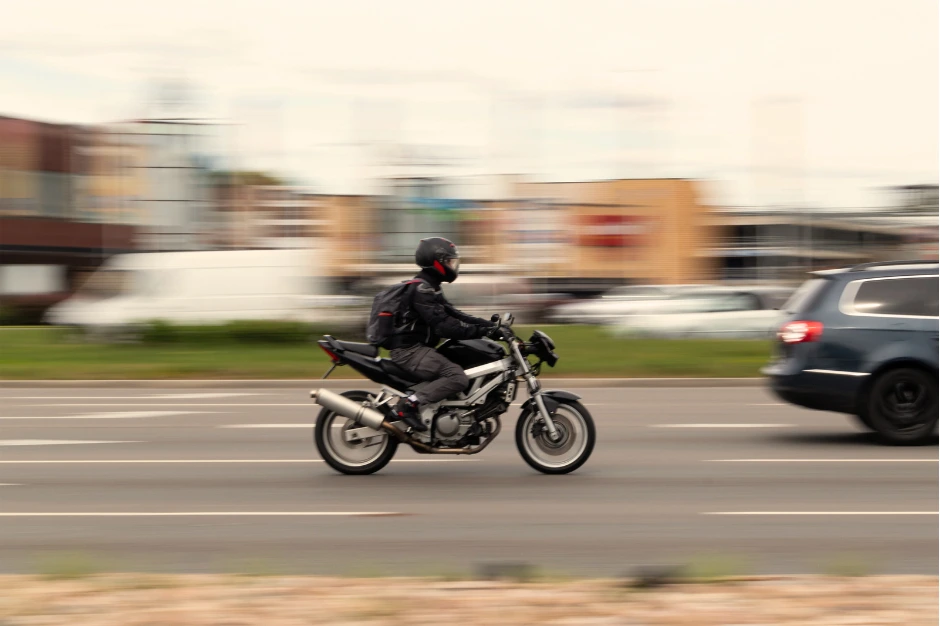 Lane Splitting vs lane filtering, image of motorcyclist on high way with blurred background, Disparti Law Group