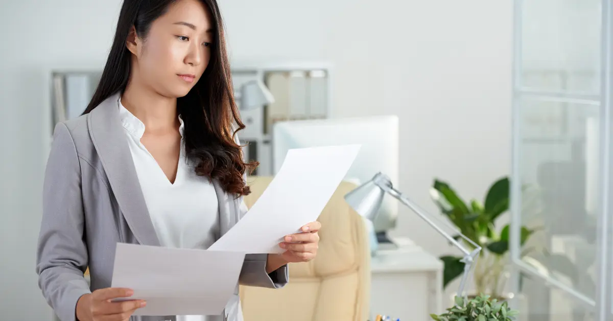 Female OnlyFans business owner organizing records before filing form 8832.