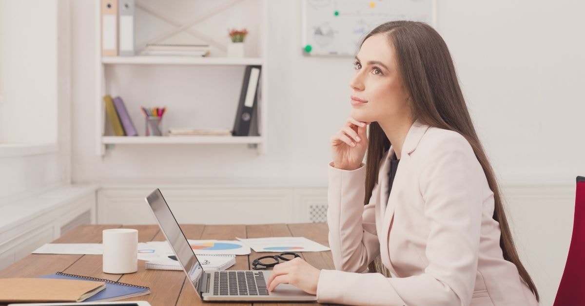 Businesswoman analyzing taxation strategies on a laptop for OnlyFans creators.