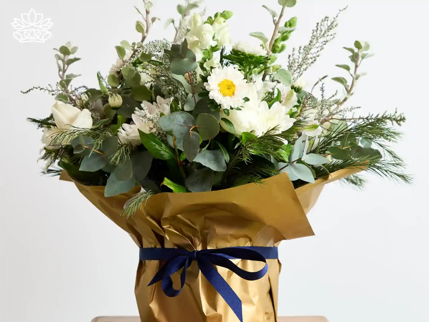 Chic and serene white and green floral arrangement wrapped in golden paper with a blue ribbon, ideal for a front desk setting, businesses reception area, creating a welcoming atmosphere.