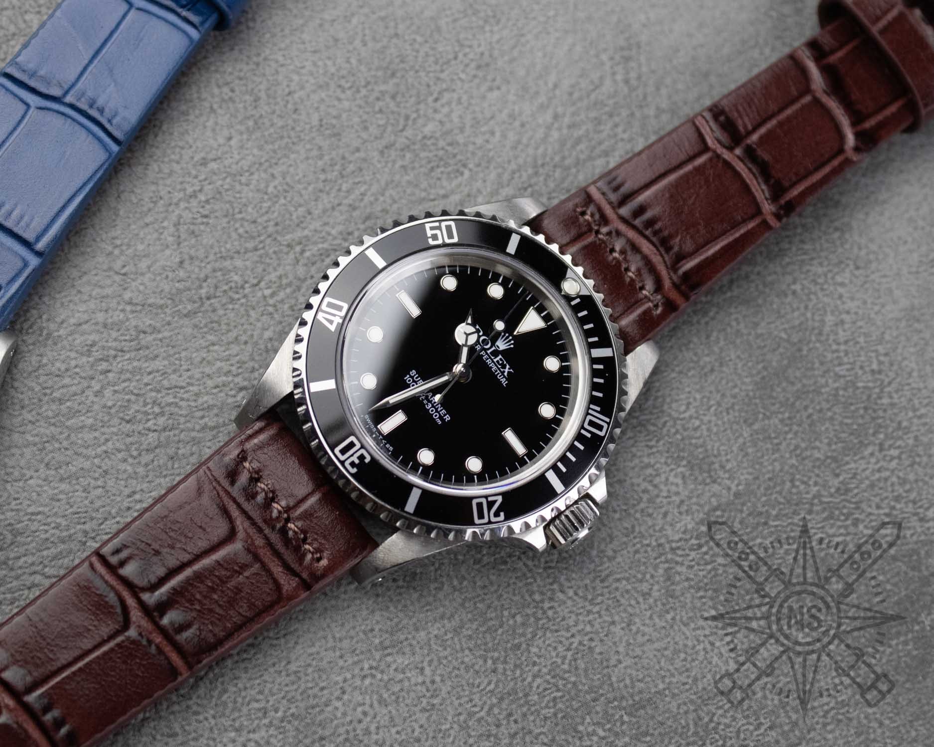 A close-up view of a brown alligator leather showcases its unique natural scale patterns and rich texture, highlighting the craftsmanship involved in creating luxurious alligator watch straps. The intricate details emphasize the sophistication and quality of this leather, making it an ideal choice for stylish watch straps.