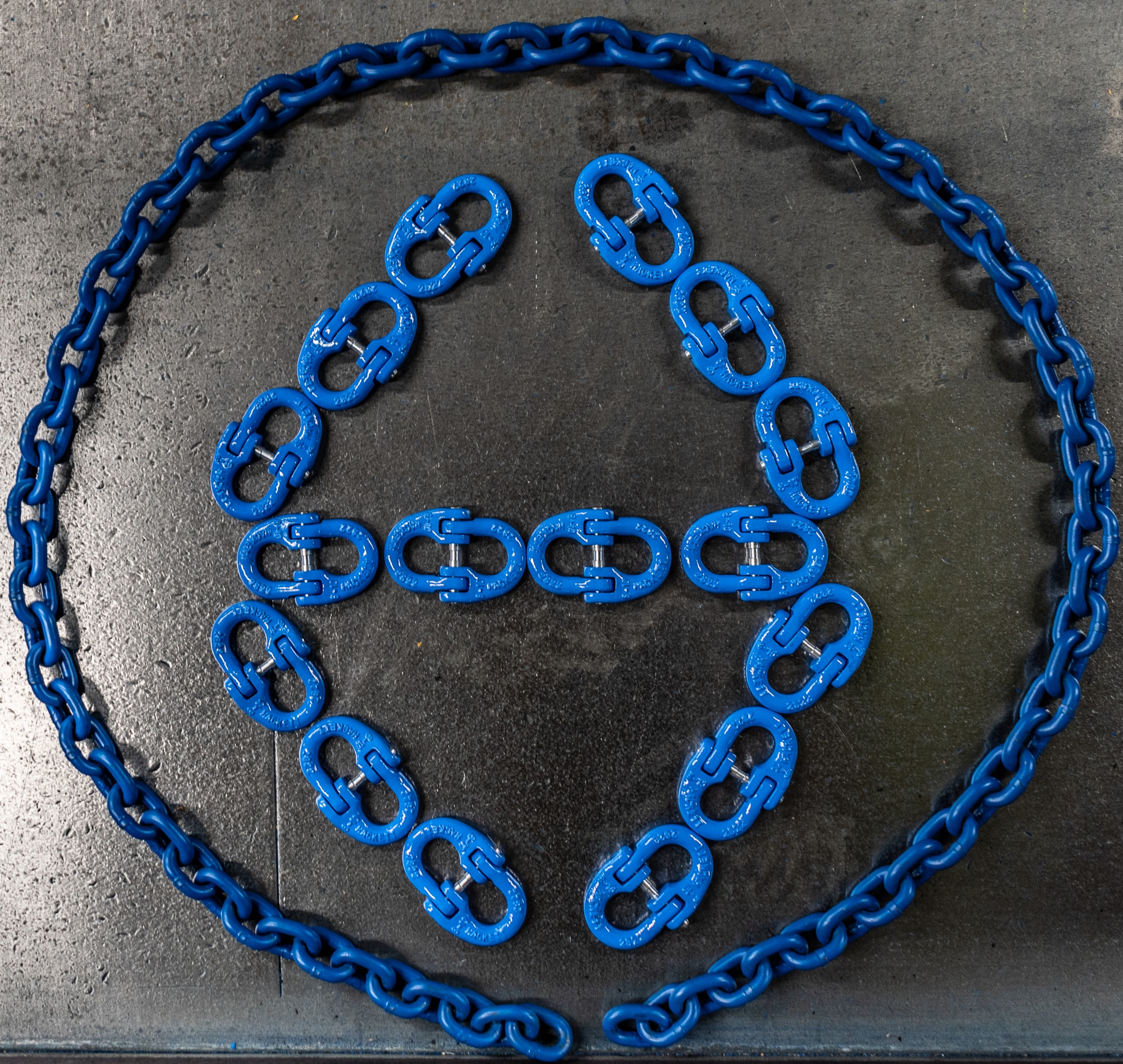 A close-up comparison showcases various parts of chain slings, highlighting their distinct link profiles and surface finishes. The image emphasizes the differences in construction and material, essential for understanding their applications in overhead lifting and rigging hardware.