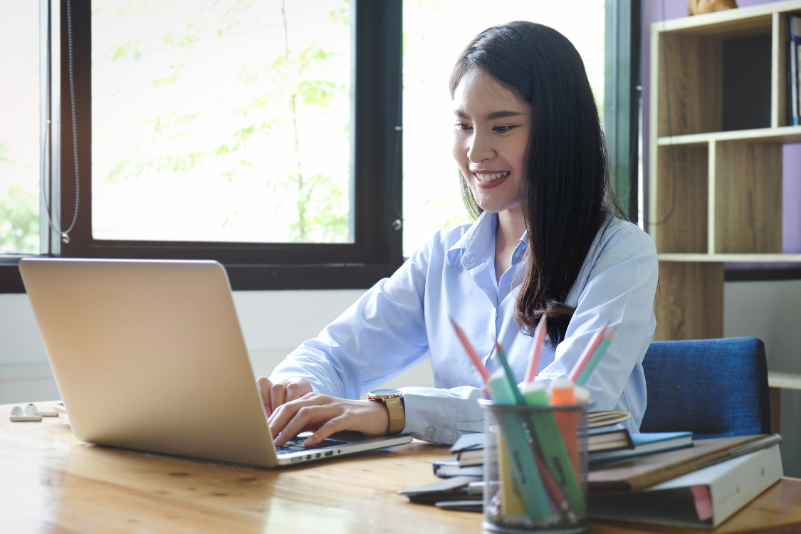 Filipino woman working remotely on a laptop from home