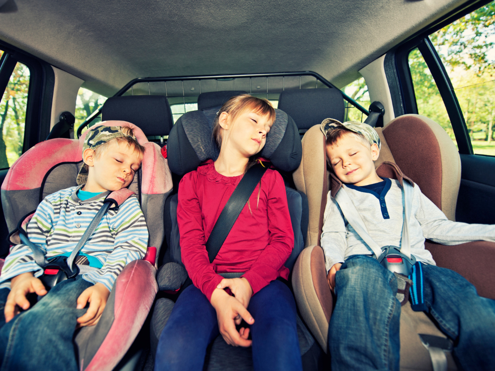 Kids asleep in their car seats - Adventure Wise Travel