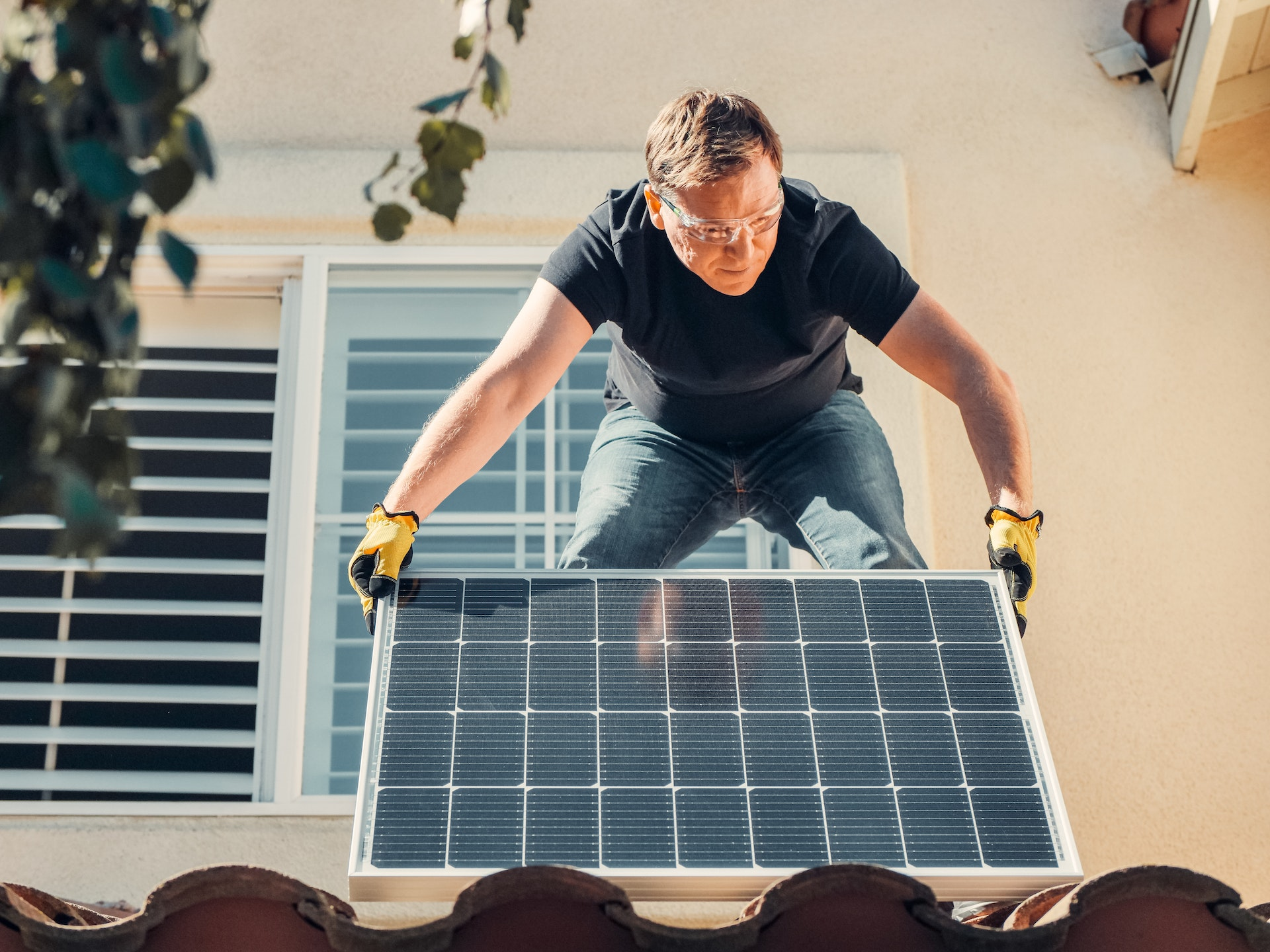 Homeowner installing a solar panel by himself. 