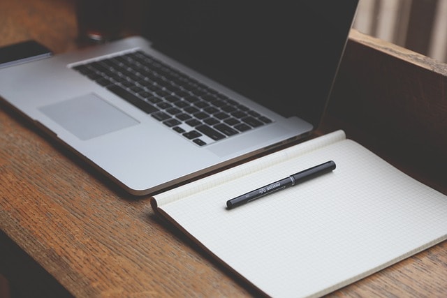 laptop and notebook symbolizing how listing optimization can boost search results and drive sales and amazon branding