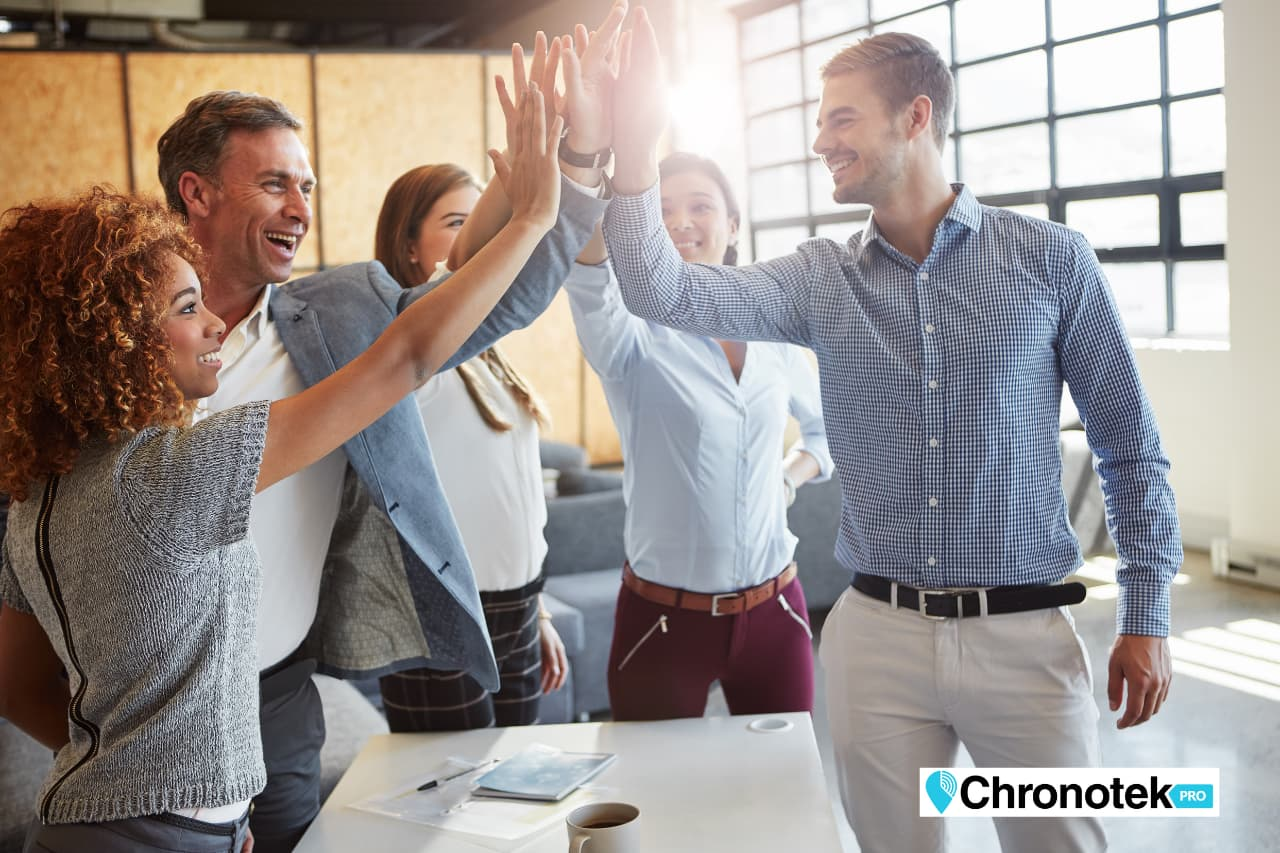 a happy management team high fiving because time tracking software gave them control of their business