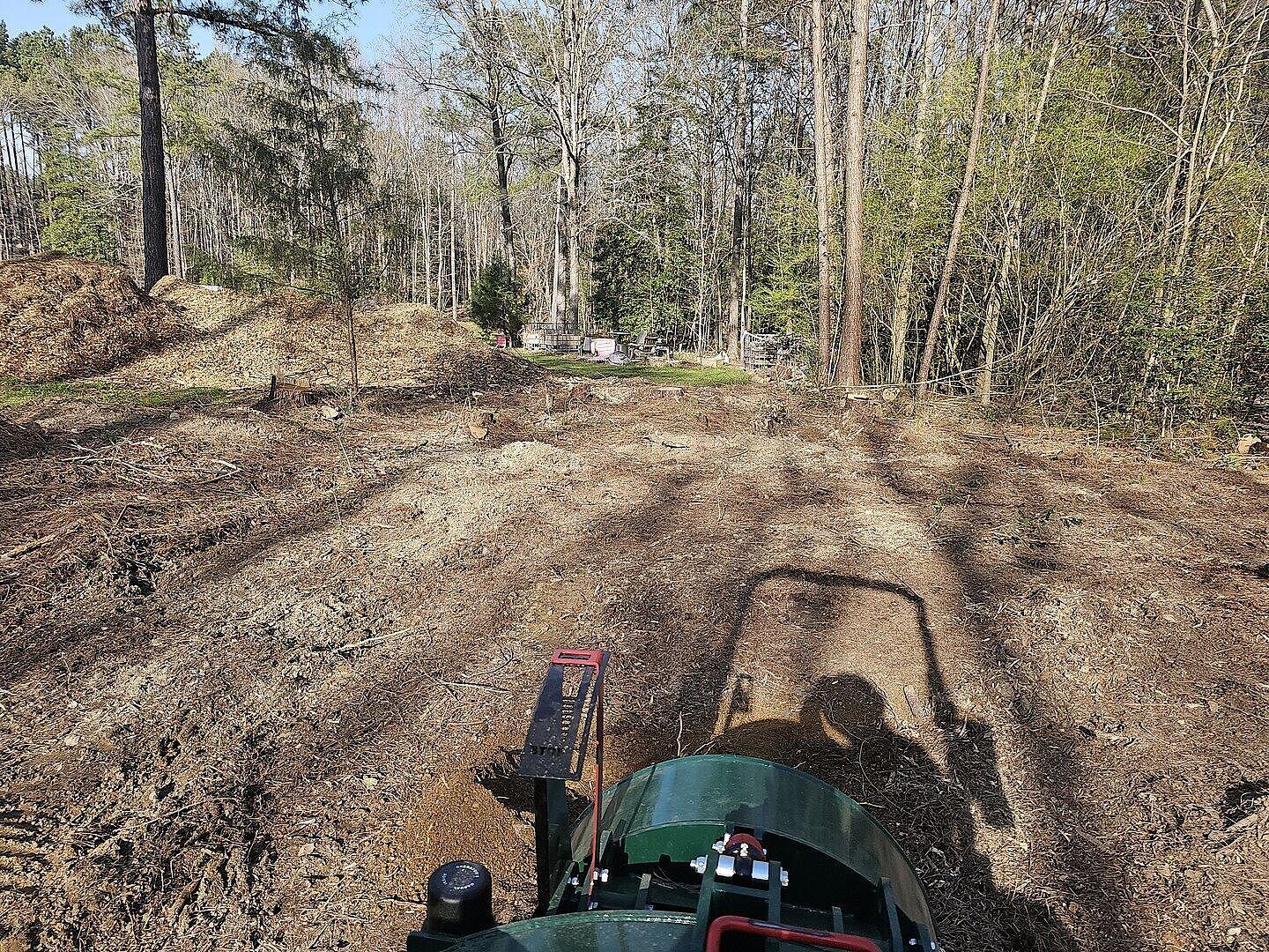 A view of a clean backyard after a stump grinding job with a Woodland Mills stump grinder in view.