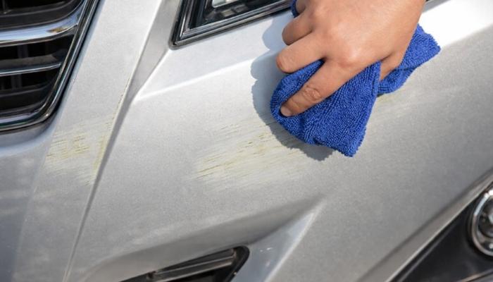 A toel is being used to clean dirt from the surface