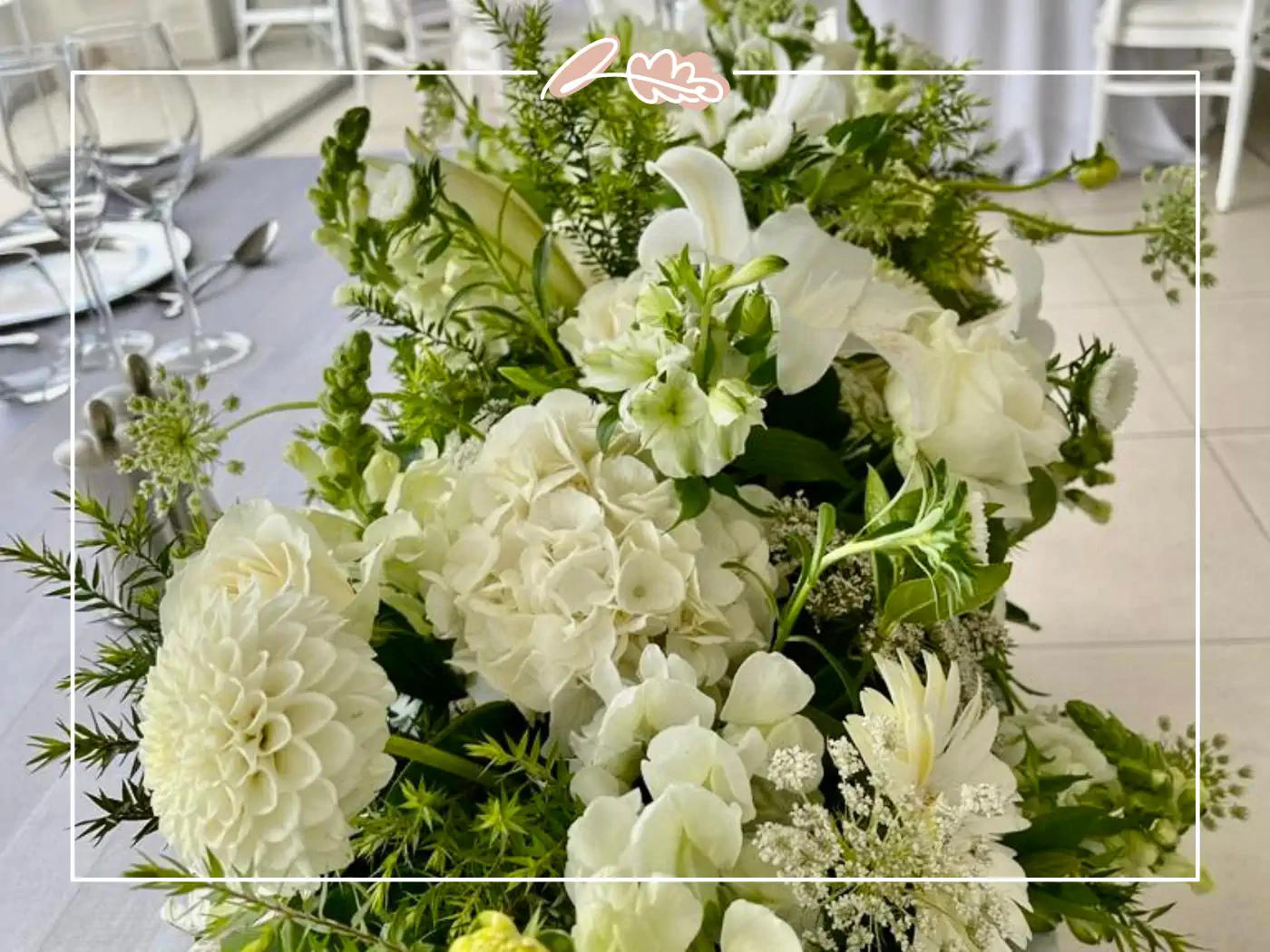 Elegant floral arrangement in white and green tones as a wedding centerpiece. Fabulous Flowers & Gifts