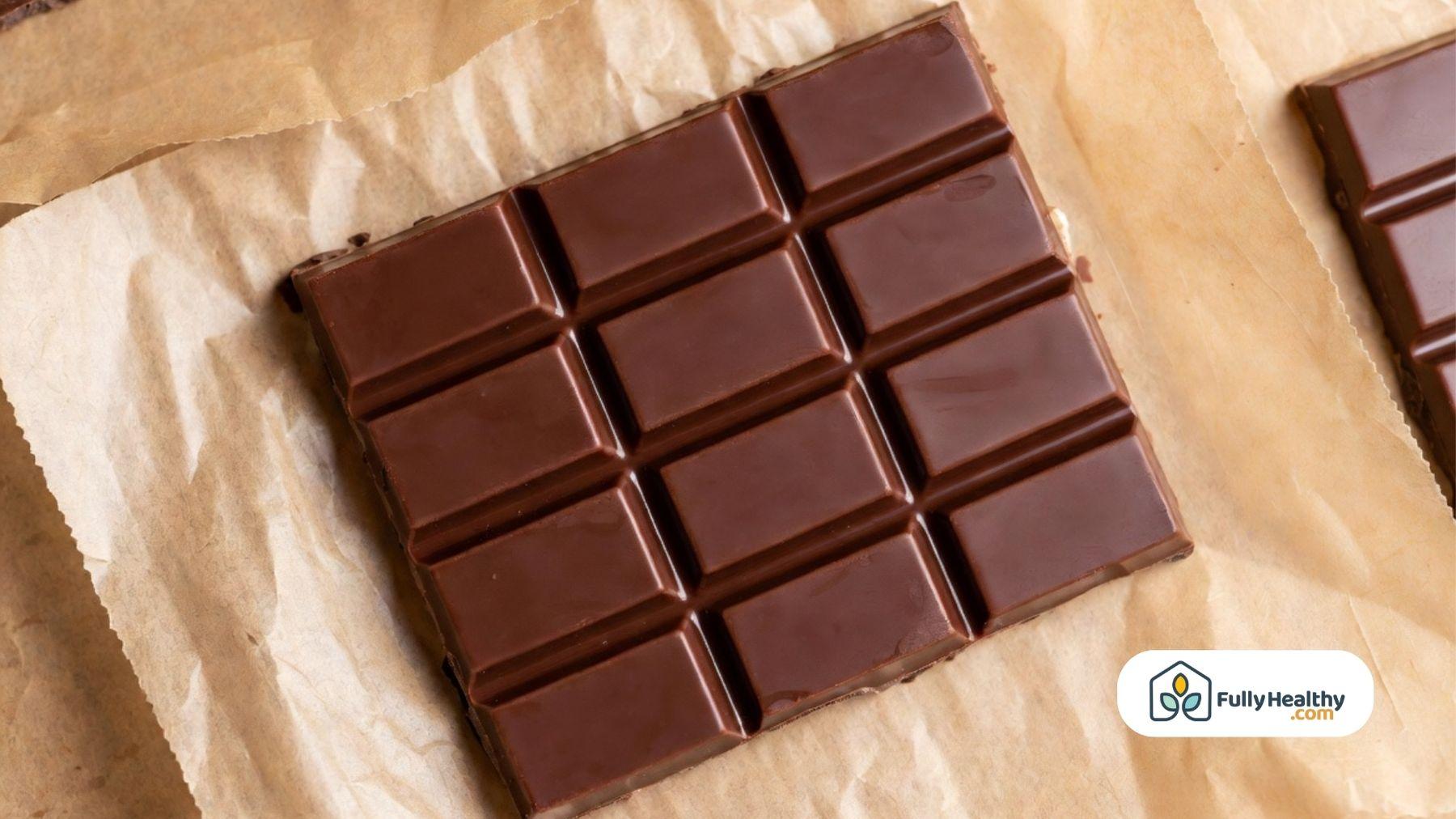 Chocolate bar placed on parchment paper with glossy finish.