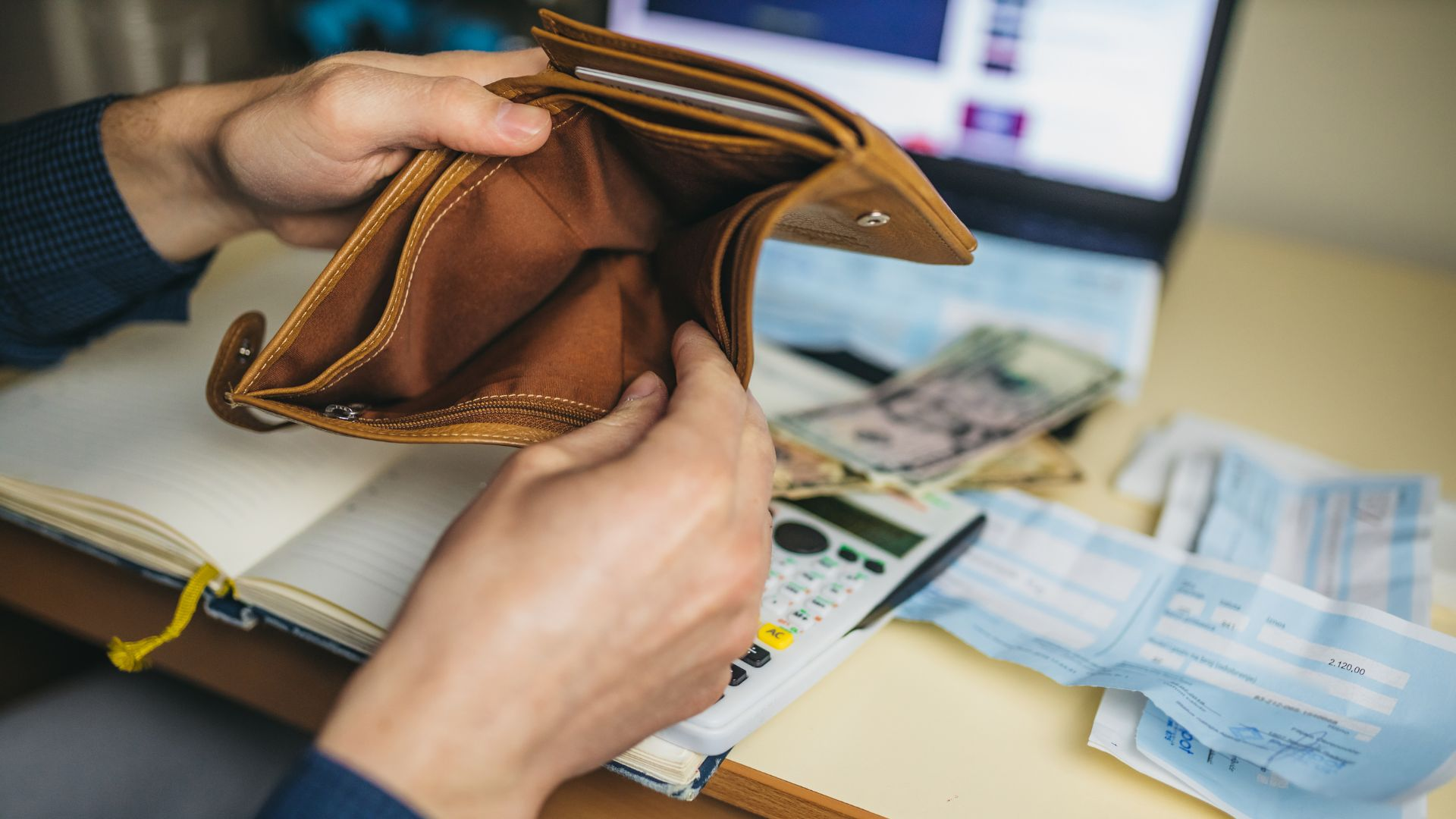 An image of a person looking in their wallet for money to pay for pest management.