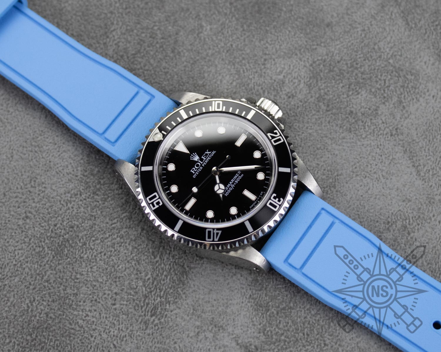 A blue rubber watch strap displayed on a watch.