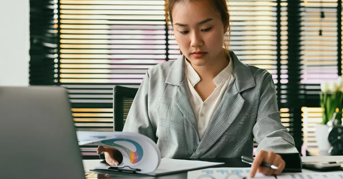 Woman reviewing payroll records and withheld taxes related to the trust fund recovery penalty.