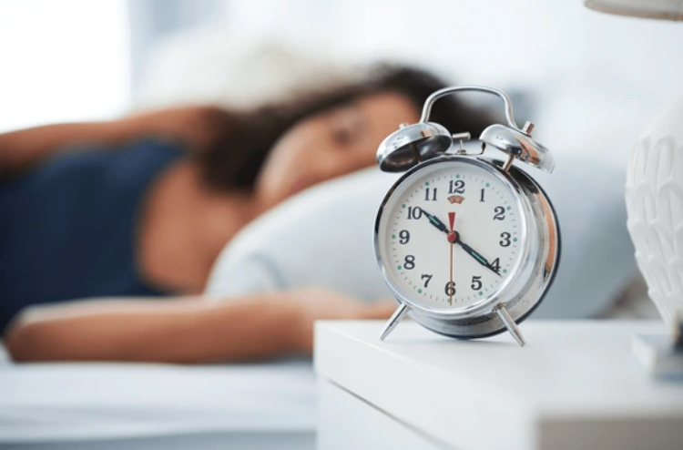 A peaceful bedroom scene depicting a person sleeping soundly, emphasizing the impact of sleep on cravings.