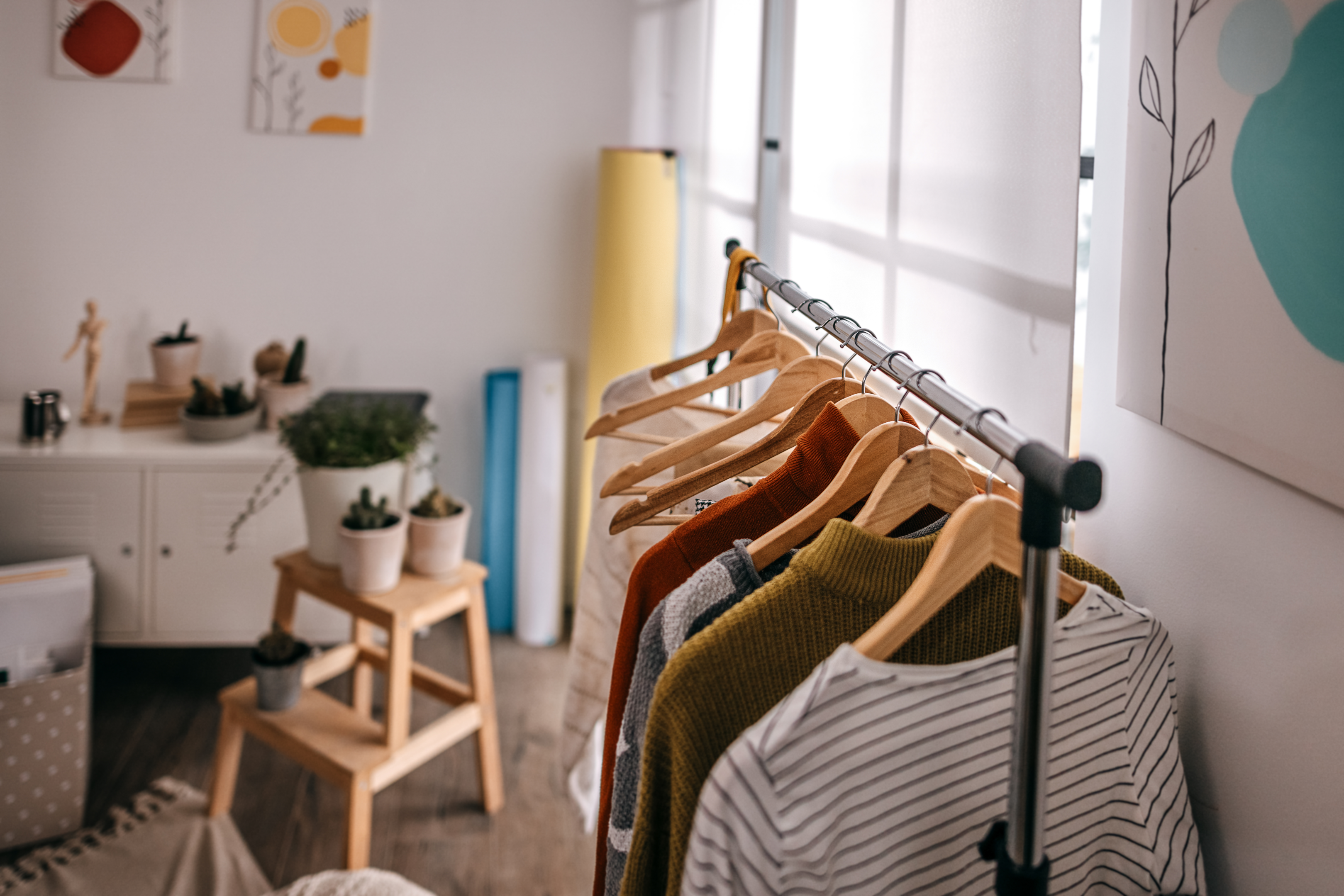 A hanging rack stored in a guest bedroom providing enough space for storage