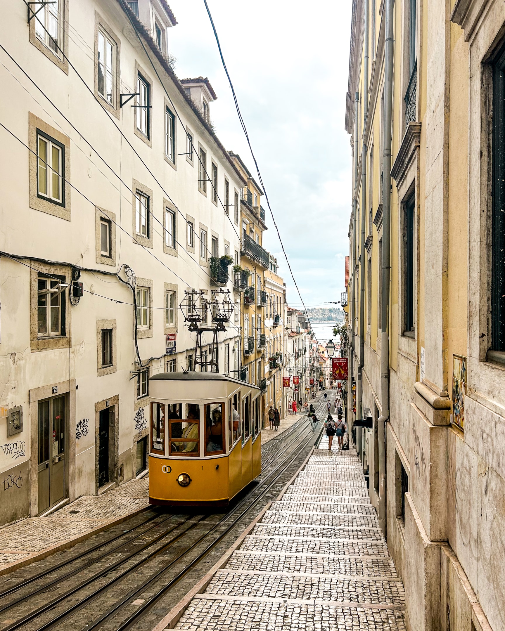 Where to Stay in Lisbon Chiado, the heart of Lisbon, featuring beautiful architecture and a yellow tram car