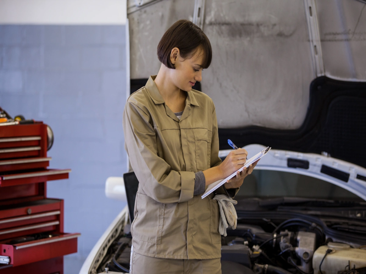 Girl inspecting car with checklist