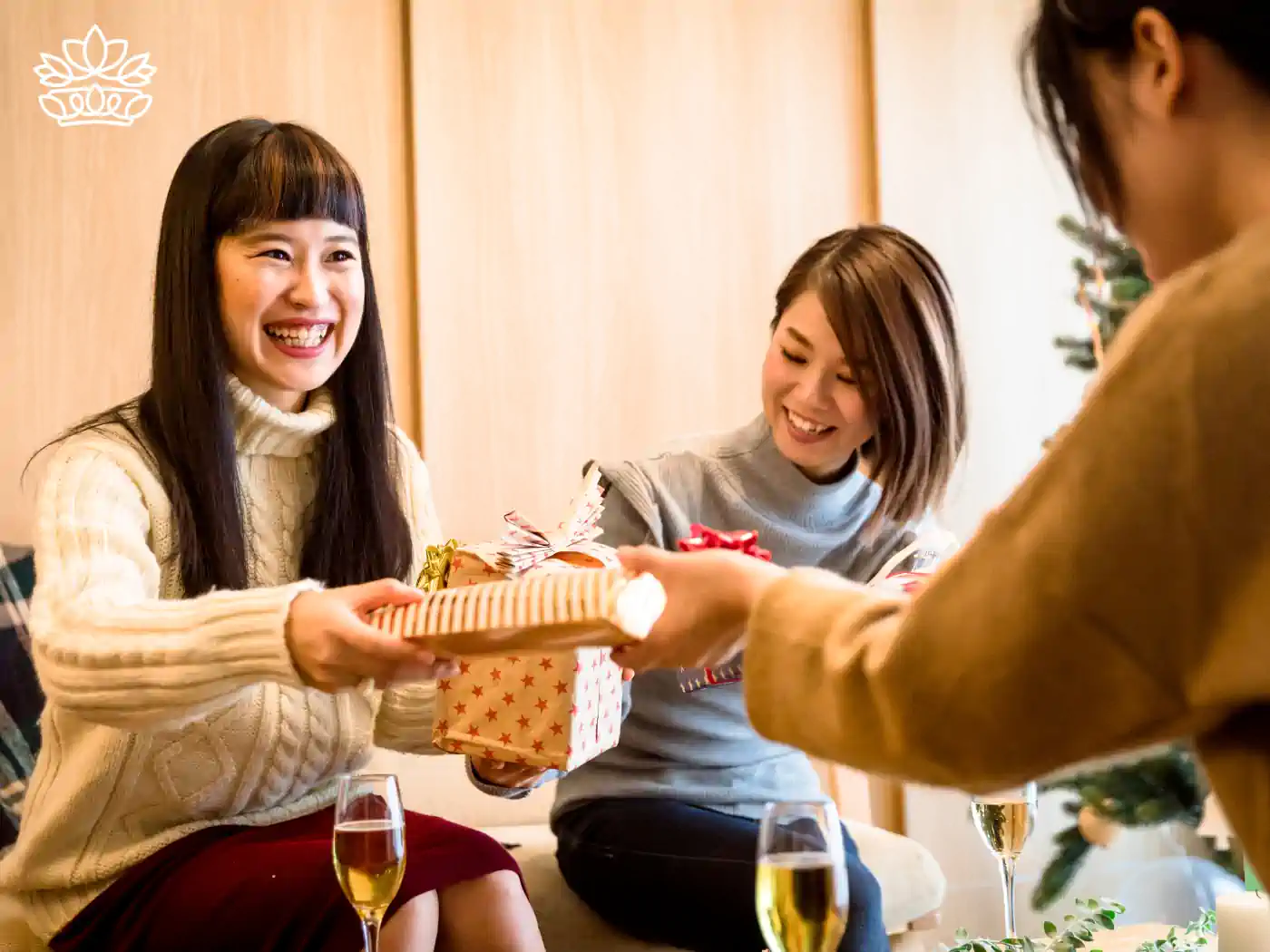 Three friends exchanging luxury gift boxes at a celebration - Fabulous Flowers and Gifts, Luxury Gift Boxes collection.