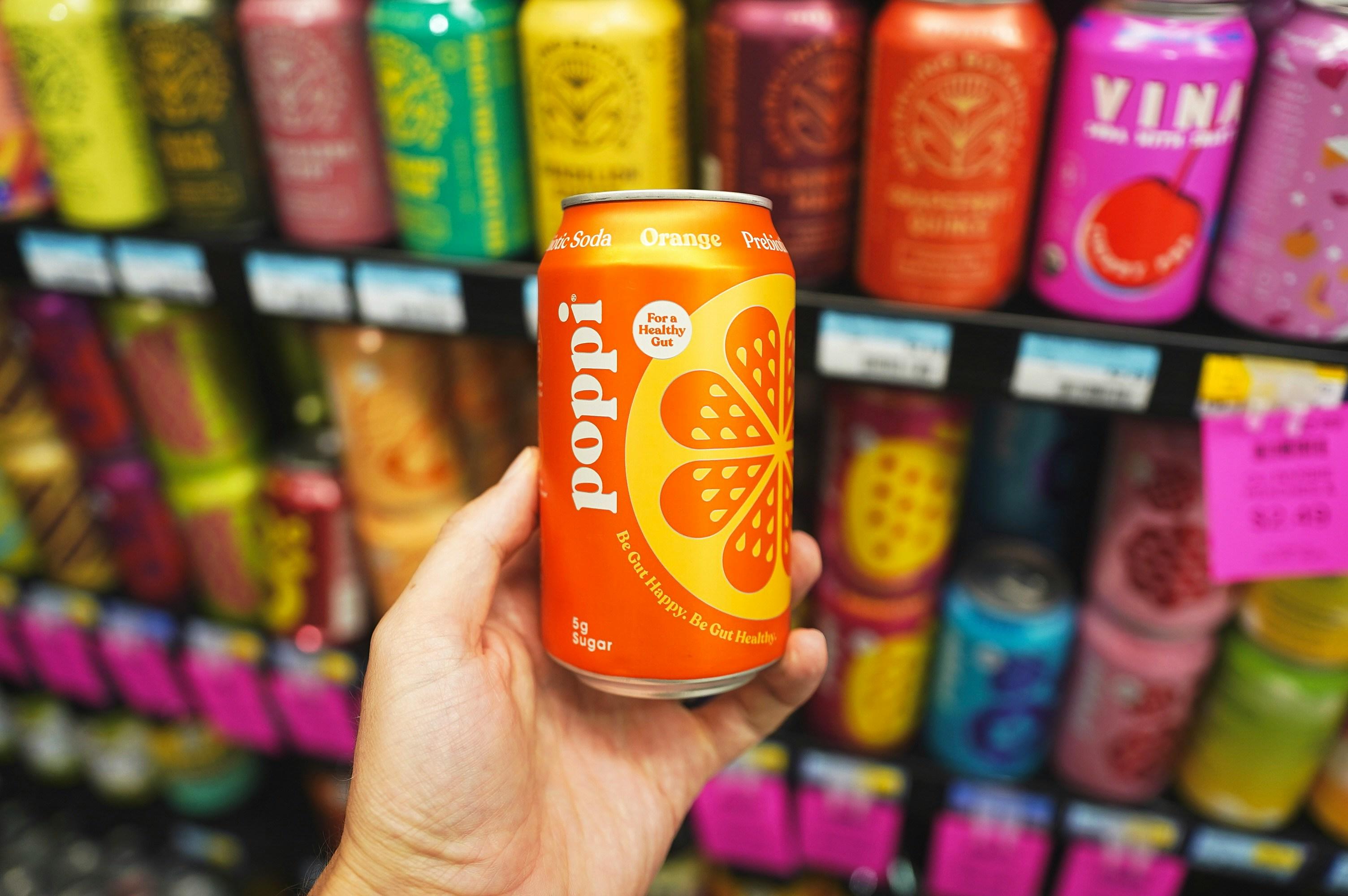 A can of orange Poppi.