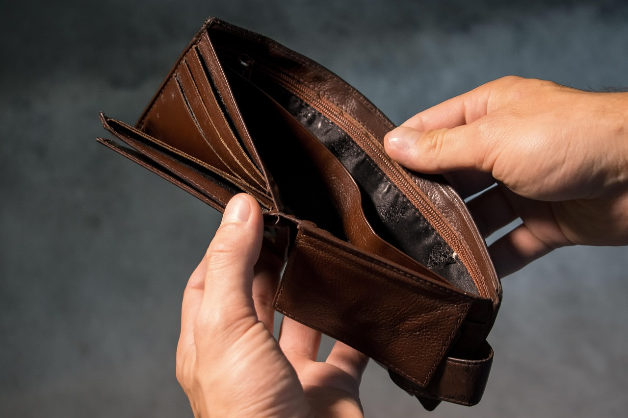 A man cleaning his wallet with a cloth