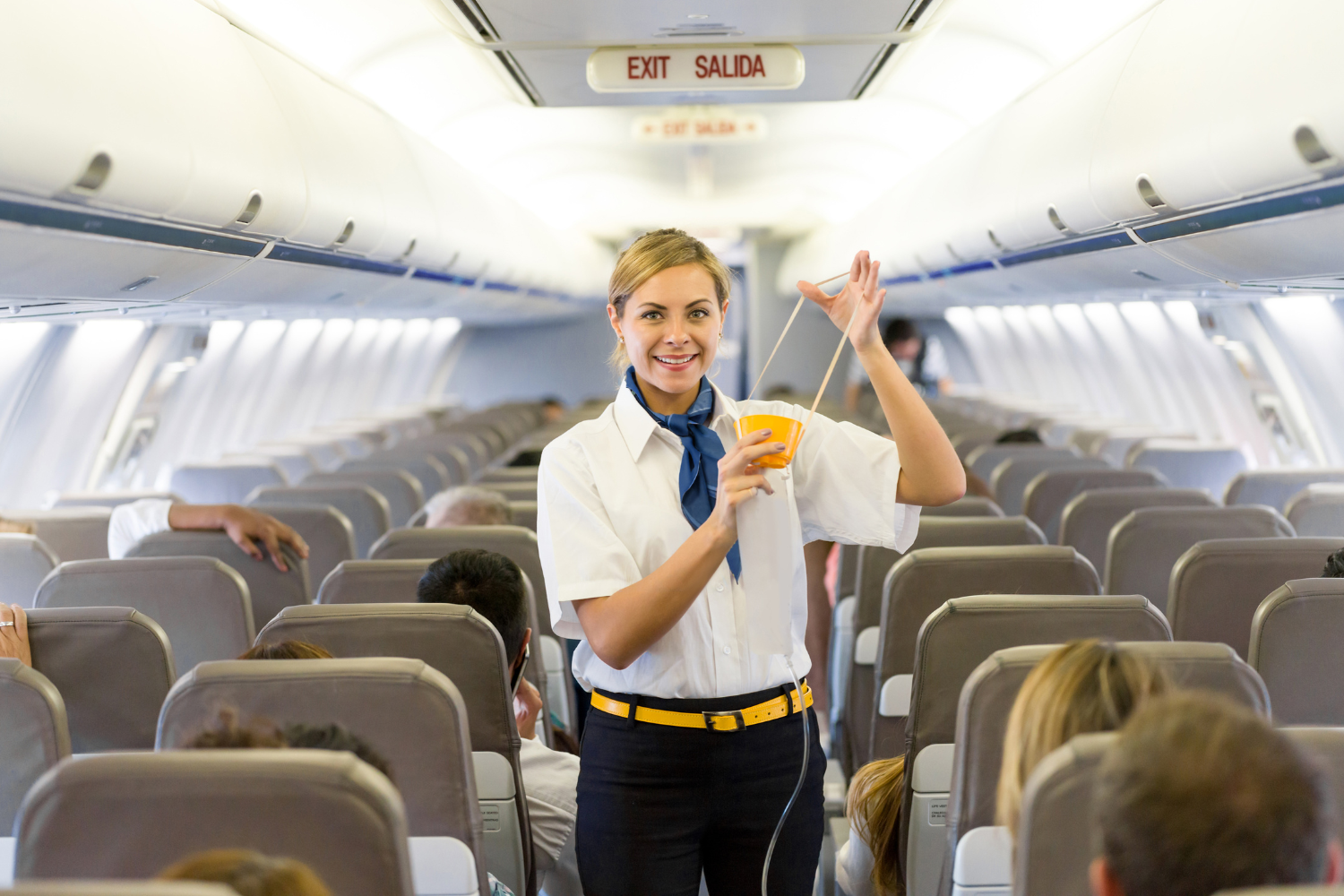 airhostess showing how to wear an oxygen mask