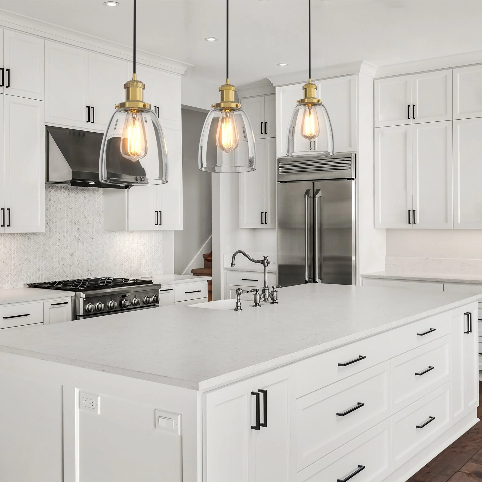 Series of three bell-shaped glass pendant lights strategically placed over a kitchen island table.