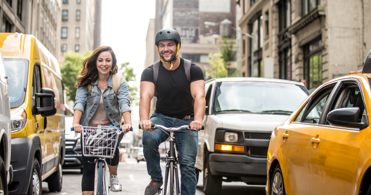 A couple riding their bikes on Fifth Avenue in New York City after successfully completing marriage counseling at Loving at Your Best Marriage and Couples Counseling.