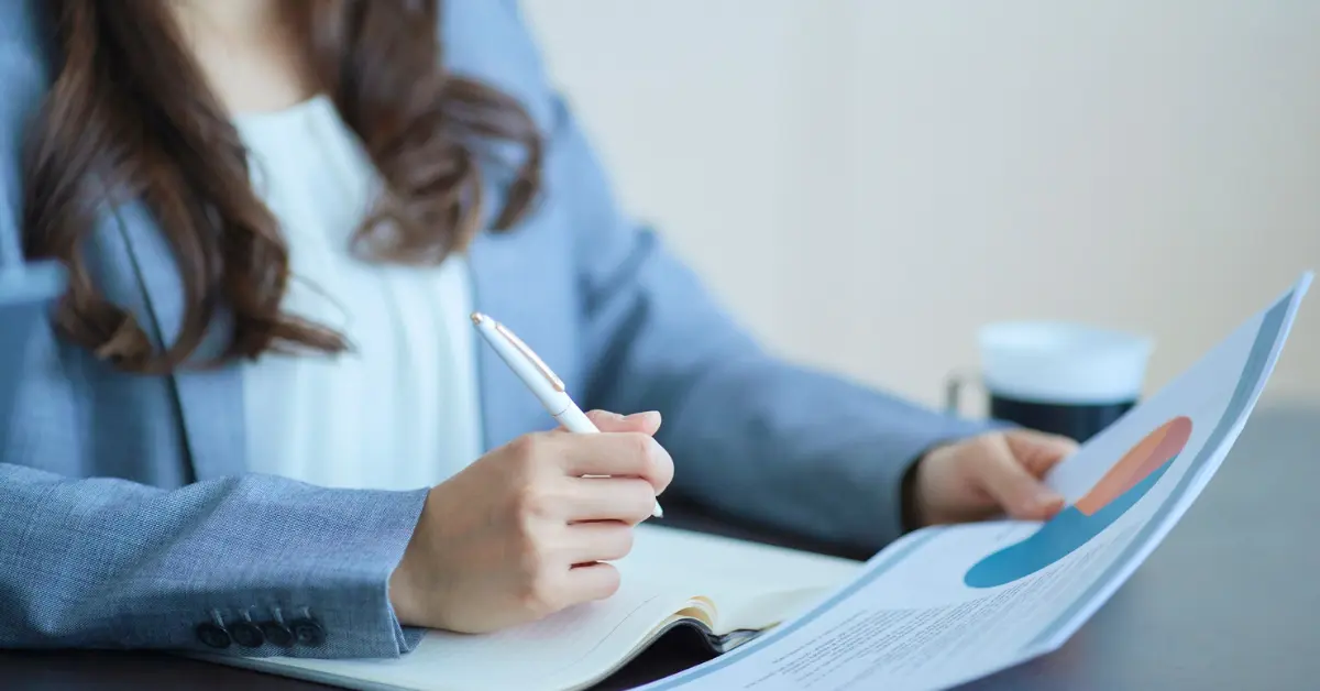 Webcam model reviewing taxes and financial documents to manage webcam modeling income.