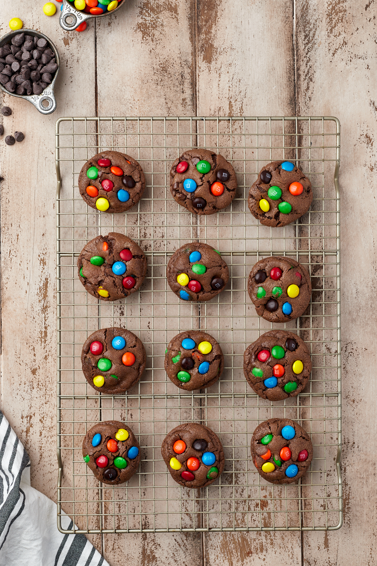 baked M&M chocolate cookies on a wire rack