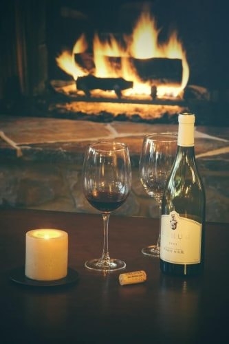 Getting into the holiday spirit with wine, electric candles, and a fireplace after seeing absolutely stunning Christmas lights
