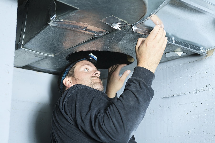 an hvac tech installing hvac ductwork