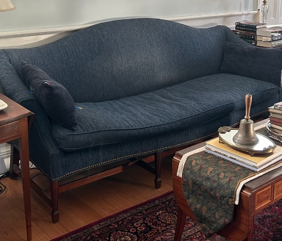 Reupholstered camelback sofa with nail head trim